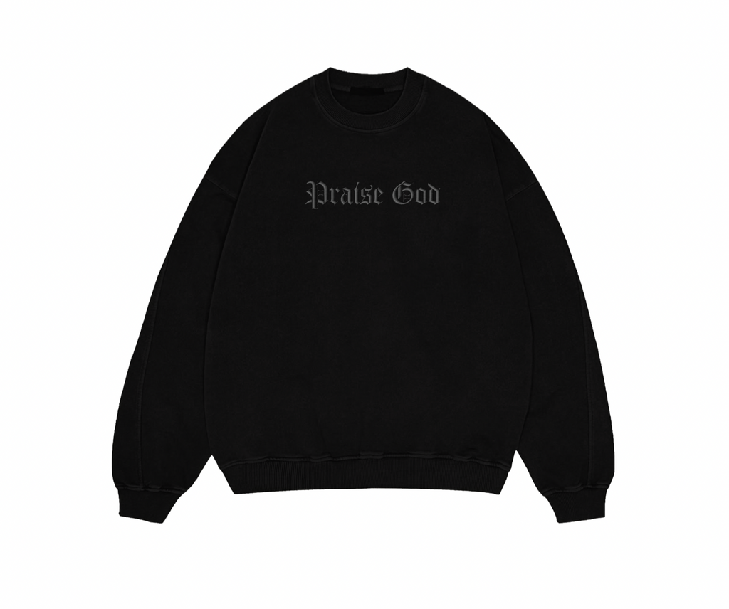 Black sweatshirt with 'Praise God' text on a white background